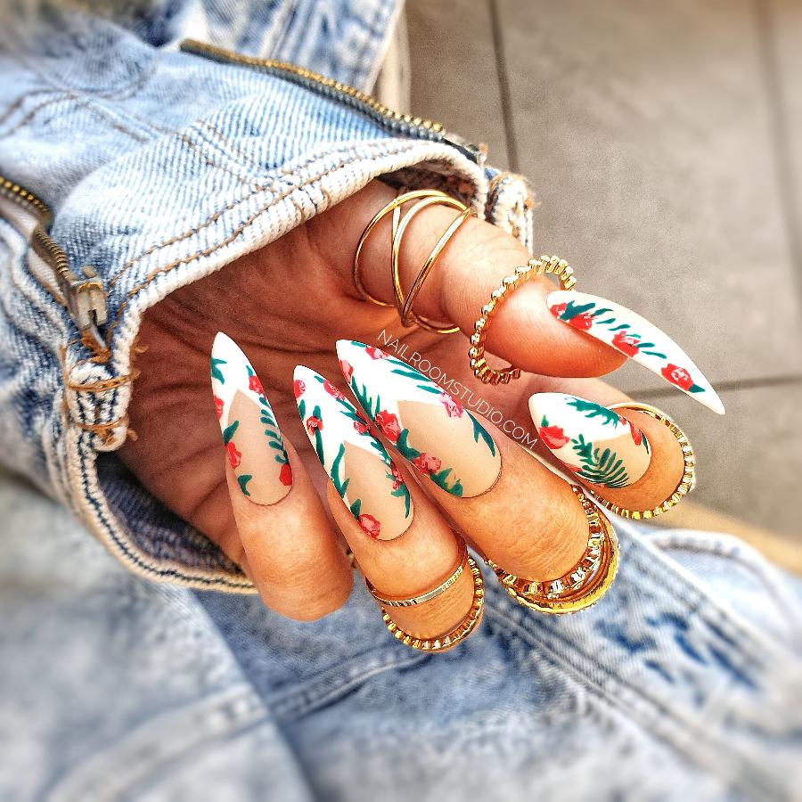 Classic French nails with hand-painted flowers and leafy accents for a soft, feminine style by Nail Room Studio