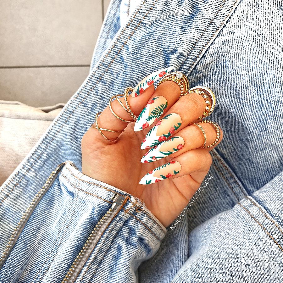 Classic French nails with hand-painted flowers and leafy accents for a soft, feminine style by Nail Room Studio