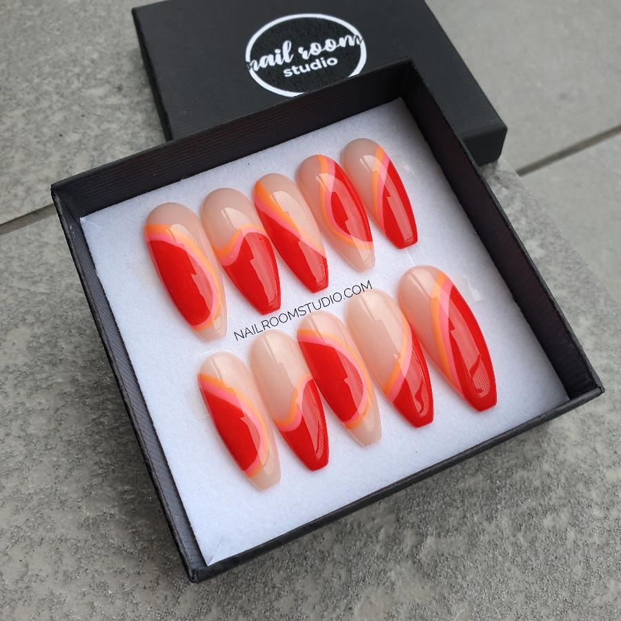 Vibrant Coca-Cola red and orange striped press-on nails with nude base and irregular wave patterns, perfect for dark skin tones, ideal for both hands and toes