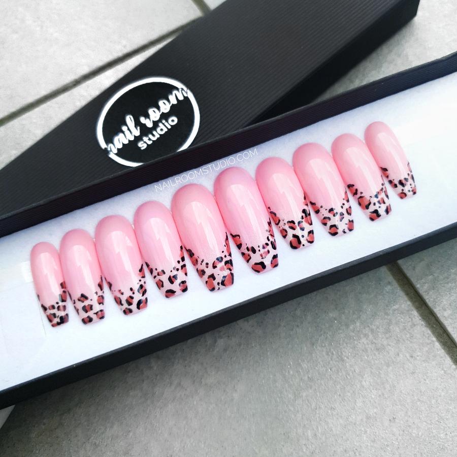 Charming pink kawaii nails with vibrant hand-painted leopard accents, designed for a fun and trendy appearance by Nail Room Studio