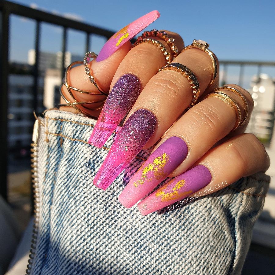 Long coffin nails in a pink and purple ombre with matte and gold chrome details, partially transparent glossy finish, ideal for vibrant summer looks by Nail Room Studio