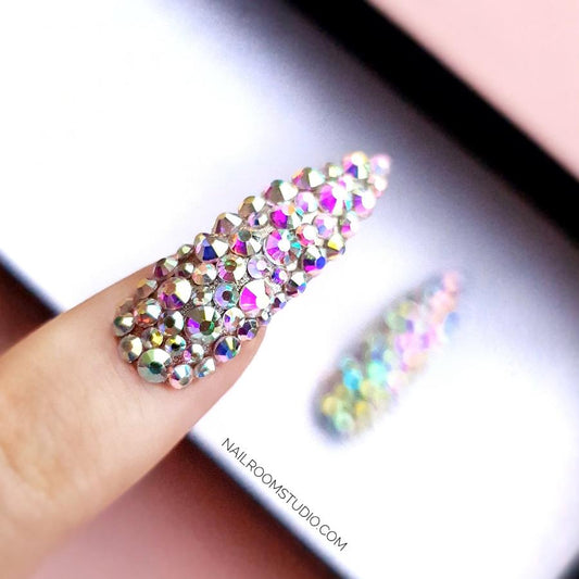 Extra-long stiletto nails with genuine Swarovski crystals and shimmering silver details, designed by Nail Room Studio