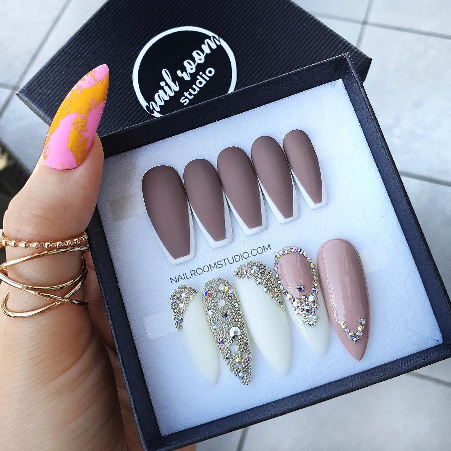 Matte nails in a cappuccino hue, accented with a classic french brown tipand the second set of bridal wedding nails, best for a chic look by Nail Room Studio