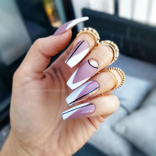 Matte mauve nails featuring asymmetrical French tips, adorned with black accents and silver glitter for a chic, sophisticated style