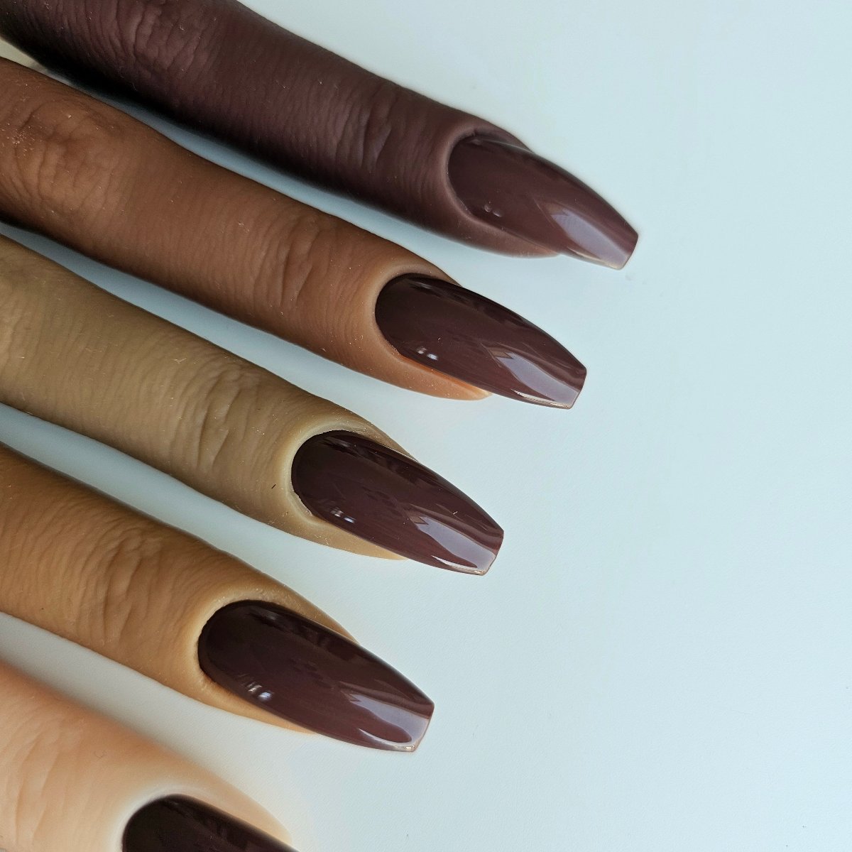 Rich deep brown press-on nails in a luxurious shade, ideal for autumn and glamorous, feminine looks by Nail Room Studio, matching shades for manicure and pedicure