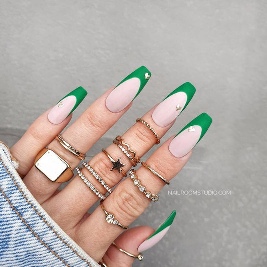 Matte nude pink nails with a vibrant green French tip and silver chrome heart accents, perfect for romantic dates and Valentine’s occasions