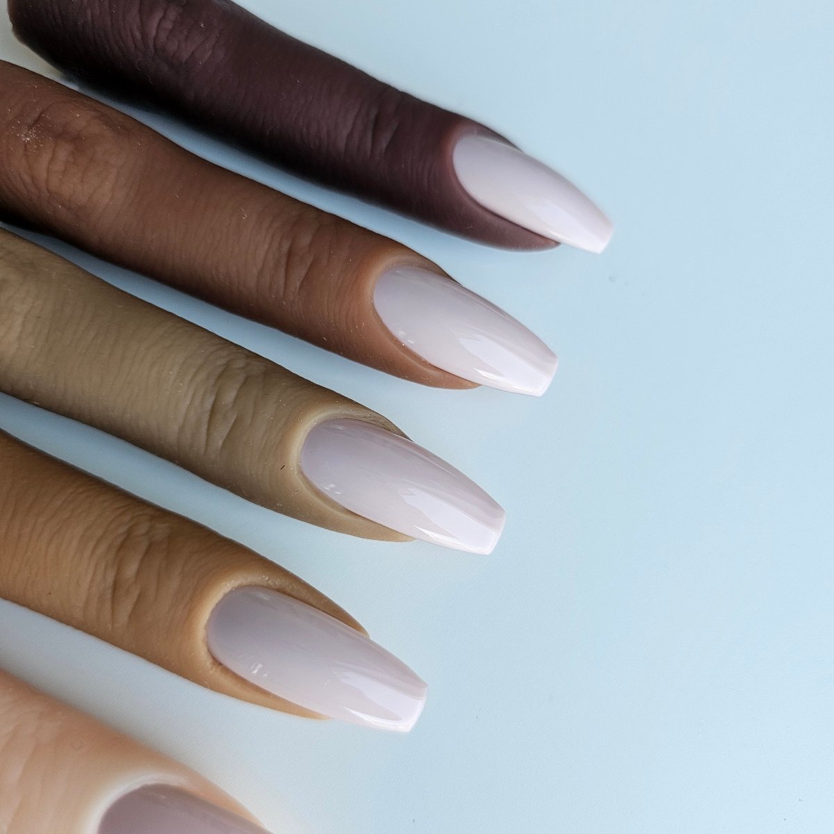 Soft pastel lilac press-on nails, ideal for weddings, with a gentle powdery hue and elegant, subtle look and color skin colors and shades swatches with nail polish