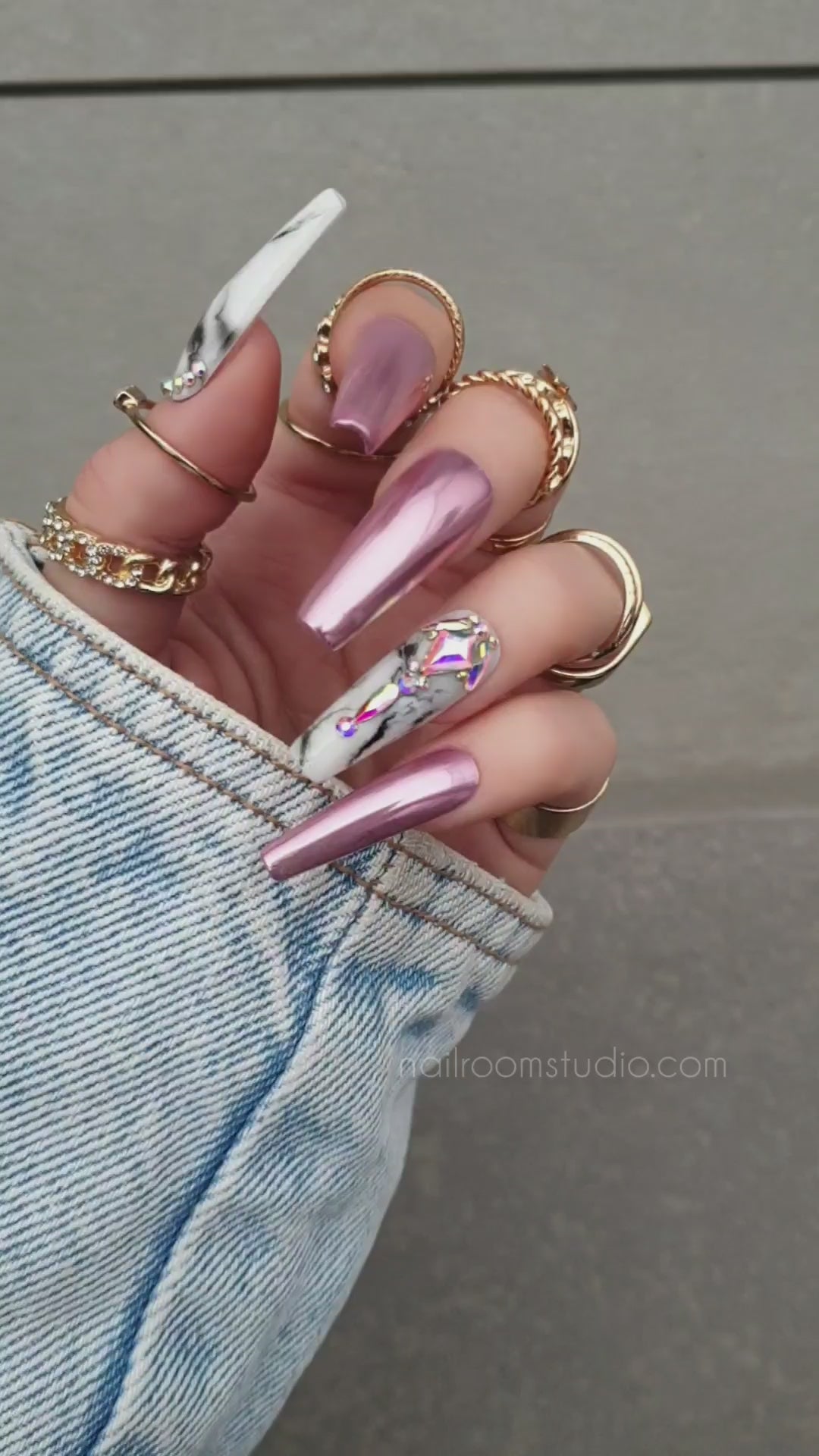 Glossy pink chrome handmade acrylic nails decorated with stunning crystals, providing a luxurious shine and a sophisticated finish