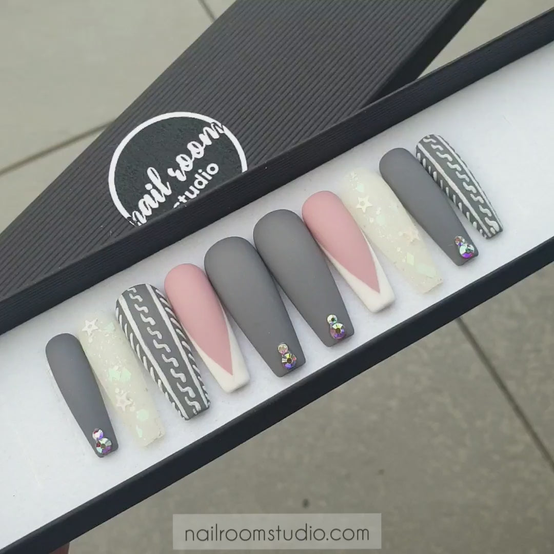 Matte sweater nails in gray and natural nude with french style and delicate frozen stars and opal crystals. A festive choice for winter season by Nail Room Studio