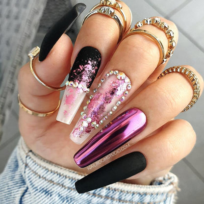 Black matte long coffin nails with shimmering pink chrome flakes and subtle AB Swarovski crystals, a refined design by Nail Room Studio