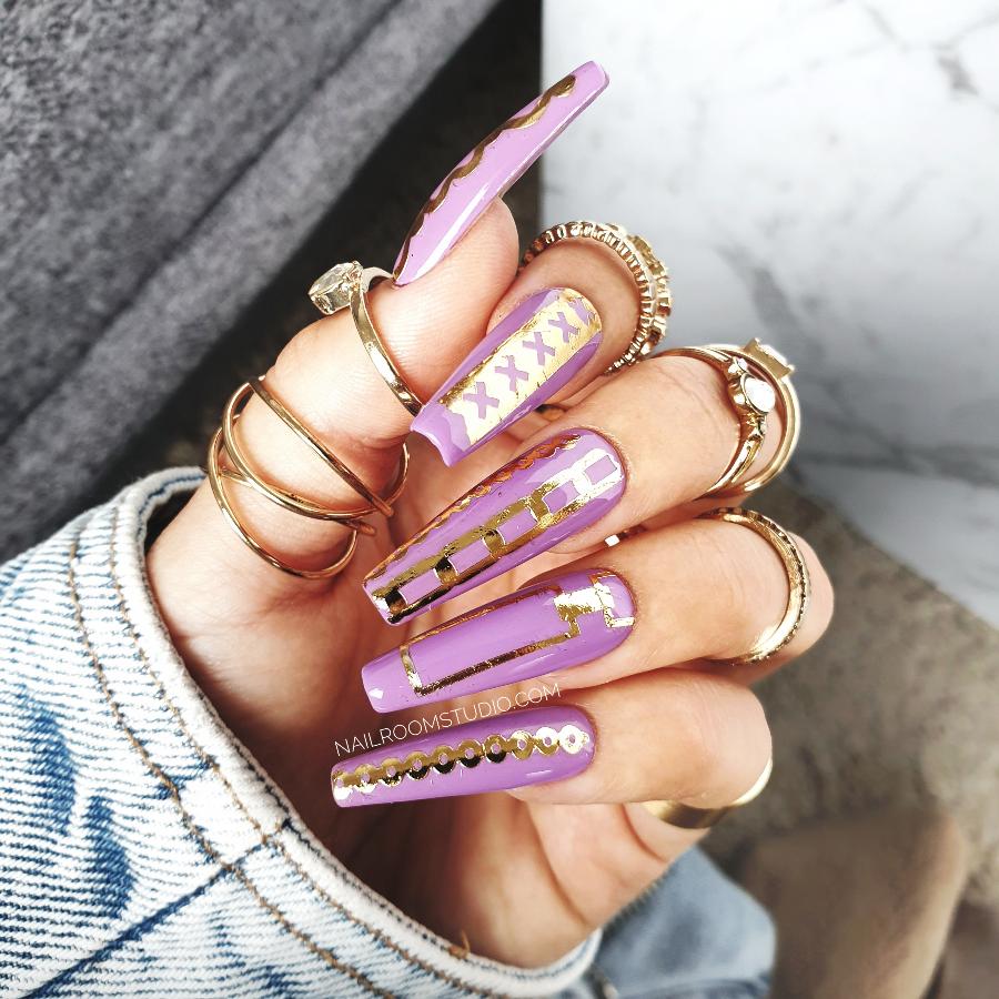 Extra-long coffin press-on nails by Nail Room Studio in lilac and purple with real gold crown nail tattoos, designed for both hands and toes pop ons