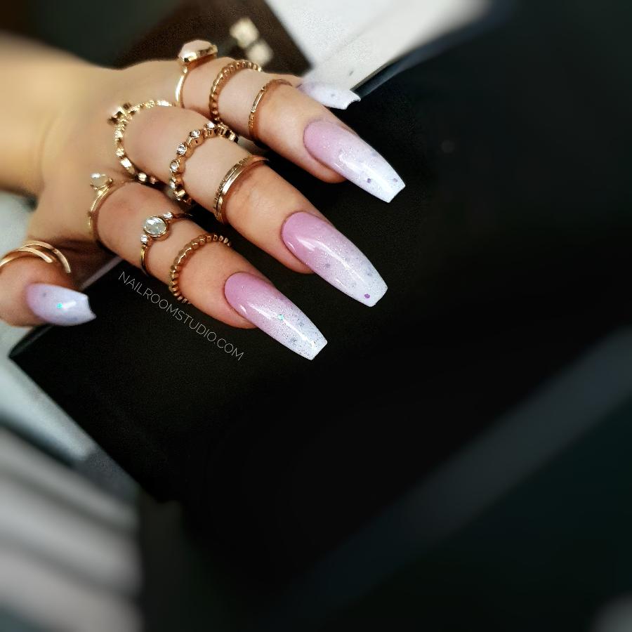 Pink and white baby boomer nails with subtle sparkles, in a natural long coffin shape by Nail Room Studio