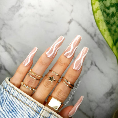 Custom long coffin salon-quality nails in peach and nude, featuring white waves design, perfect for a chic pedicure or manicure, includes glue for easy application from Nail Room Studio