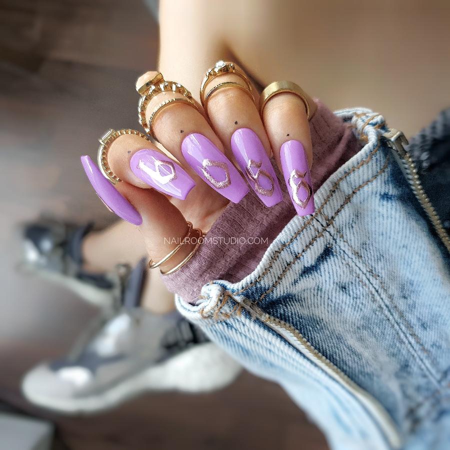 Vibrant pink nails with "boss girl" text with a summer-ready look, featuring glossy chrome lettering and a bold, eye-catching style from Nail Room Studio