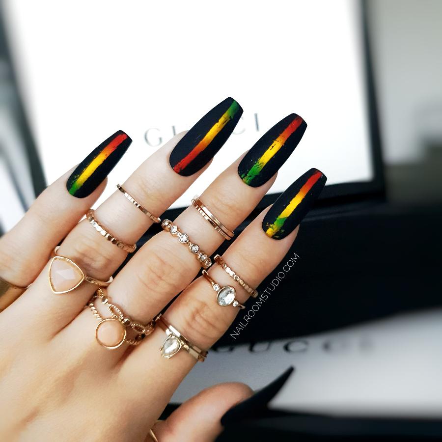 Black gothic coffin nails with a matte finish and chrome highlights inspired by African colors from Nail Room Studio