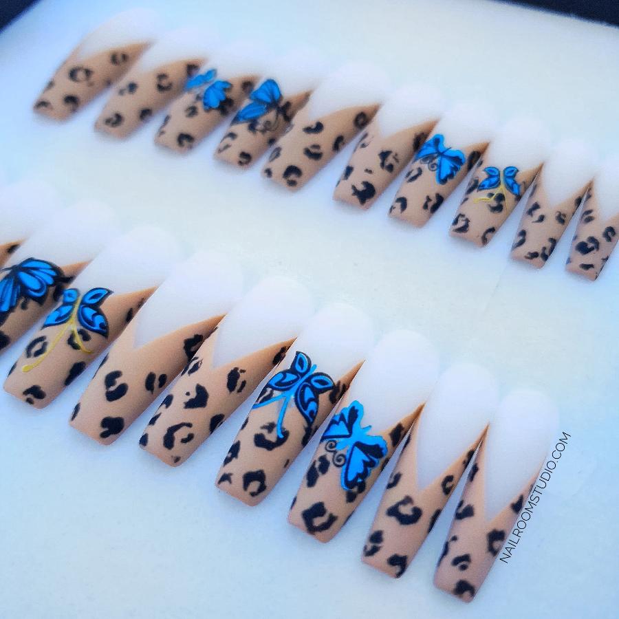 Set of 20 long sculpted coffin acrylic nails showcasing a chic panther print on french tips, enhanced with blue butterfly motifs and brown and beige