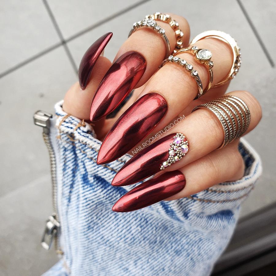 Elegant red chrome wedding nails with pearl and crystal jewelry accents by Nail Room Studio in a long steel rose style