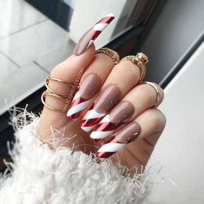 Candy Cane-inspired French nails with red chrome accents, white and red stripes, and a design perfect for Christmas, winter, and festive celebrations, matching pedicure and manicure by Nail Room Studio