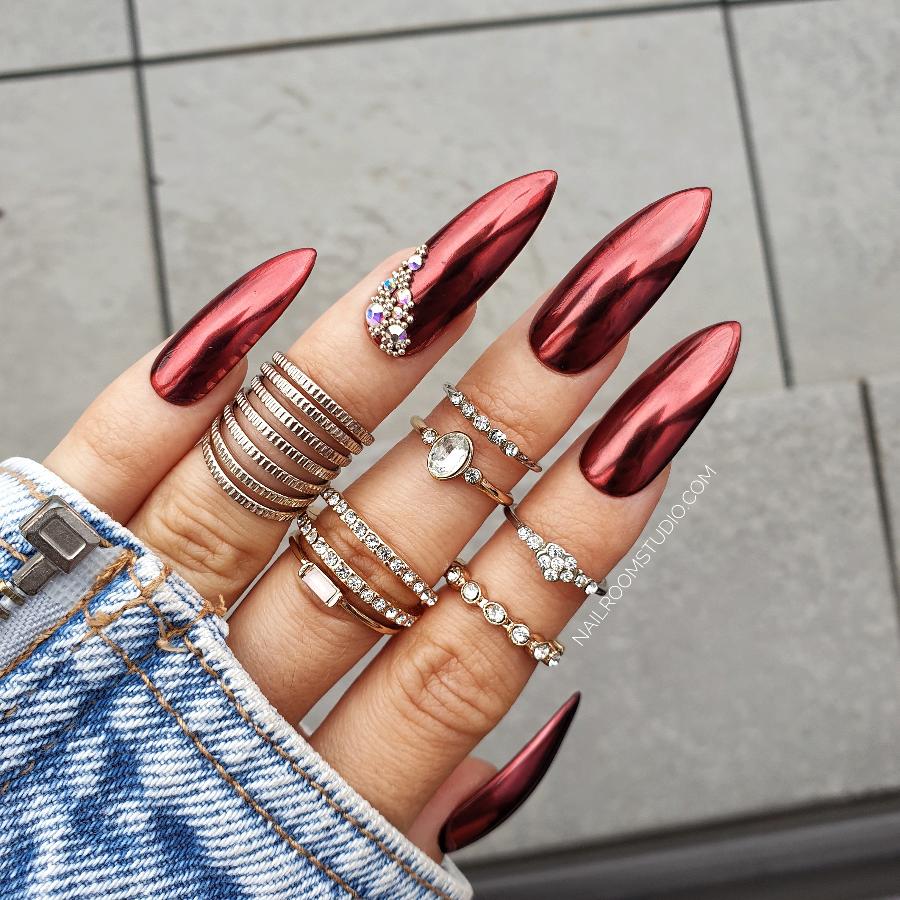 Fun fatale red chrome nails with bridal pearl and crystal decorations in a long steel rose shape from Nail Room Studio