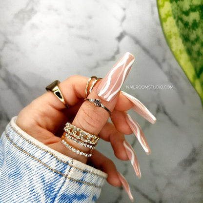 Stylish peach and powder pink custom press-on nails in long coffin shape, with white waves design, perfect for both hands and toes, salon-quality glue included, summer nude press ons