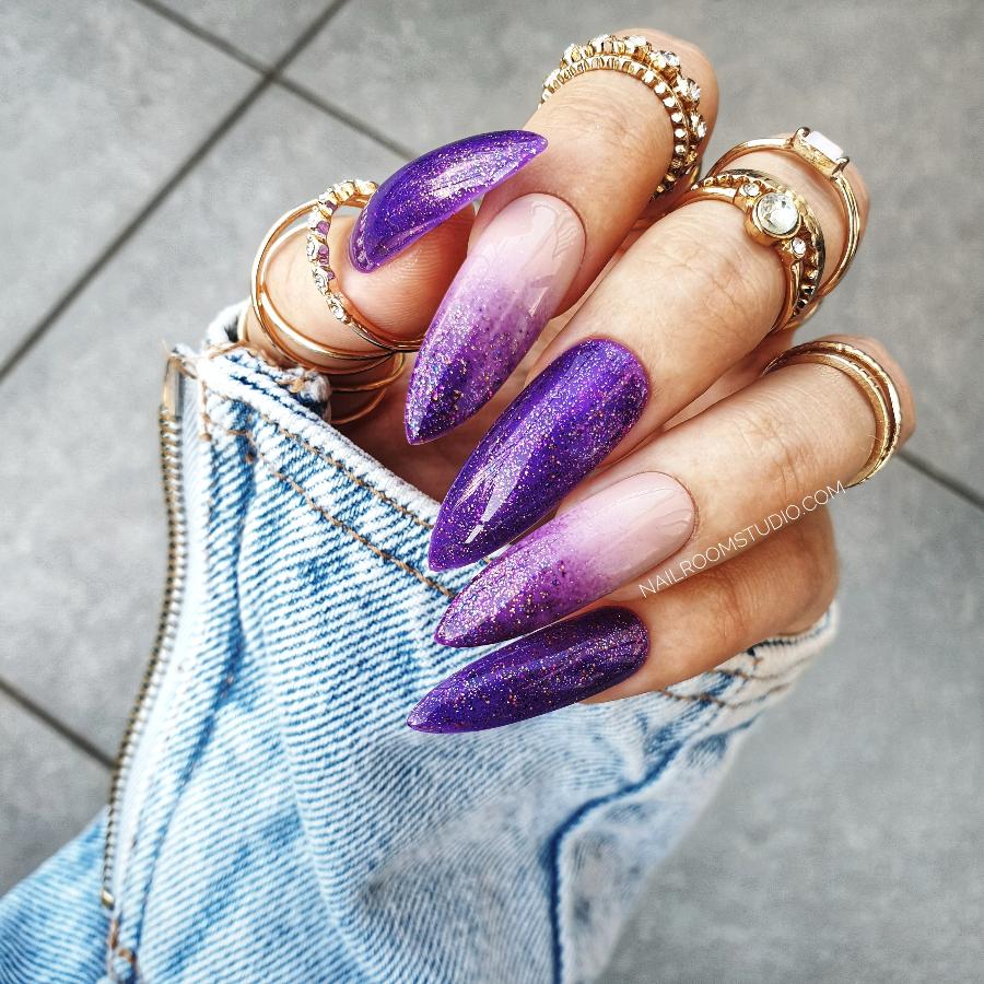 Purple ombre nails in a long fileto shape, with glitter and nude accents, designed with a mystical, witch-inspired aesthetic by Nail Room Studio