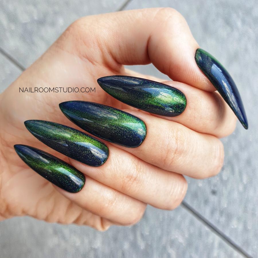 Luxury stiletto nails with dark green cat-eye shimmer, perfect for a witchy, wizard-inspired look by Nail Room Studio