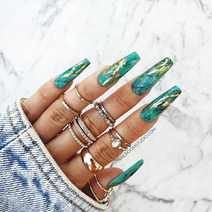 Long sculpted coffin nails with adhesive nail tabs and glue in shades of green with a marbled finish, golden chrome accents, toes and hands false nails and water-painted details, perfect for a rich autumn look