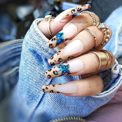 Full set of 20 professional acrylic long sculpted coffin nails with a handmade panther print on french tips, adorned with blue butterfly motifs and brown and beige accents by Nail Room Studio