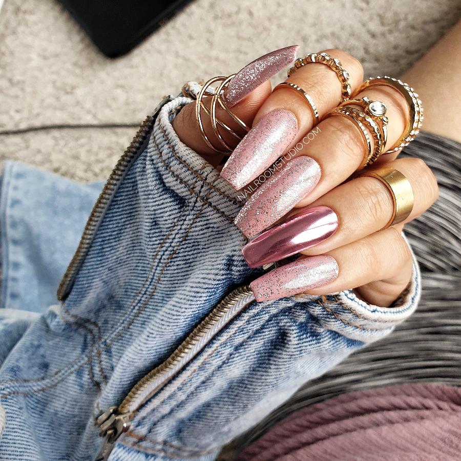 Light pink chrome press-ons with nude glitter details, offering a delicate finish in long cup-in style from Nail Room Studio