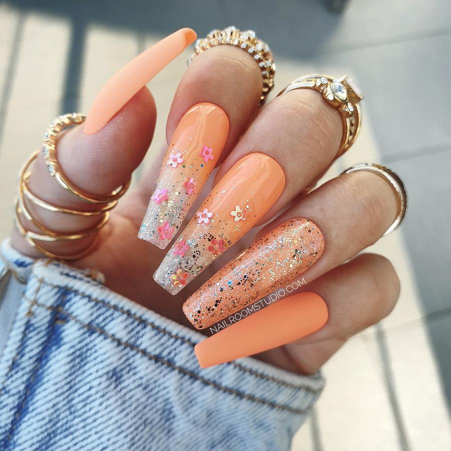 Long sculpted coffin nails in juicy orange with matte and glossy chrome glitter, ombre with milky tips, perfect for summer style, matching toes available by Nail Room Studio