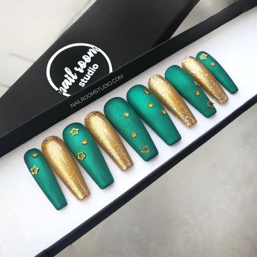 Matte green nails with gold chrome and delicate star details, a chic winter look. Designed for Christmas season by Nail Room Studio