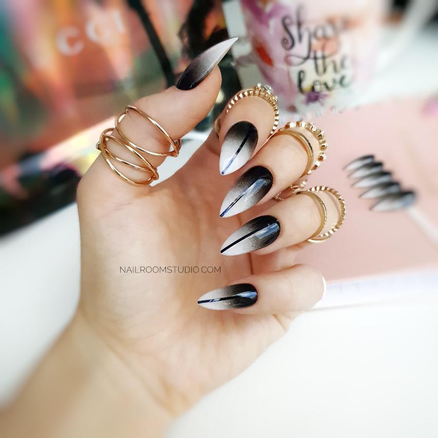 Gothic ombre stiletto nails in black and white, accented with a bold black line, perfect for Halloween by Nail Room Studio