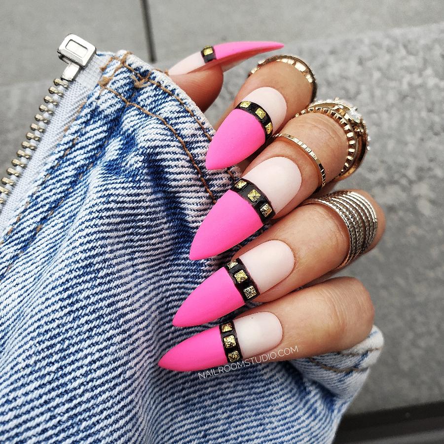 Ultra pink faux nails with nude pink tips, black stripe, and gold gems by Nail Room Studio, ideal for darker skin tones