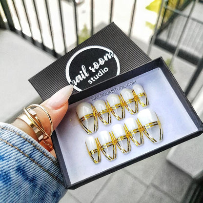 Chic clear coffin nails embellished with glamorous gold French designs, ideal for a touch of luxury by Nail Room Studio