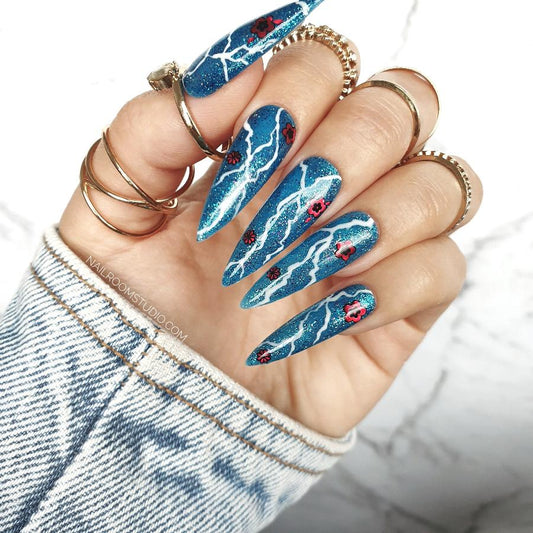 Glossy blue nails by Nail Room Studio in long sculpted style with glitter, rose design, and lightning accents for a bold statement, short-term-nails