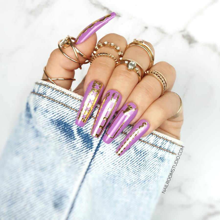 Beautiful lilac and purple extra-long coffin nails by Nail Room Studio with gold crown nail tattoos, suitable for hands and toes manicure