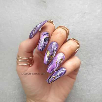 Lilac, purple, and pink long coffin press-on nails with custom hand-painted marble patterns, perfect for both toes and hands, offering a one-of-a-kind, elegant style 