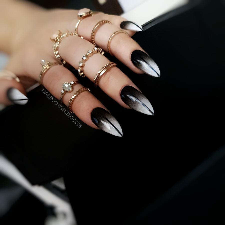 Halloween-inspired medium stiletto nails with ombre black and white design by Nail Room Studio