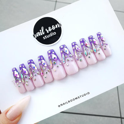 Magical ombre nails in lilac, pink, and violet, featuring Swarovski crystals, custom witchy design, long coffin acrylic nails, easy-to-apply fake nails from Nail Room Studio