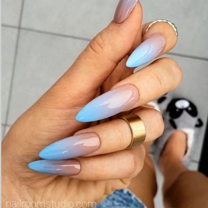 Nude and baby blue ombre stiletto nails for a soft, natural look by Nail Room Studio