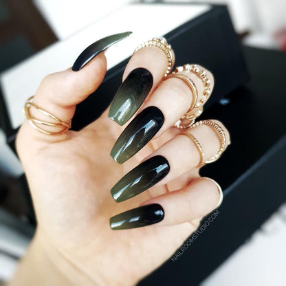 Long coffin nails with a black and green ombre effect, featuring matte and glossy finishes by Nail Room Studio