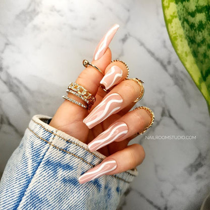 Beautiful peach and nude long coffin nails with a chic white waves design, ideal for a personalized look, salon-quality press-on nails, includes glue for pedicure and manicure