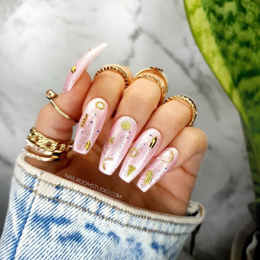 Feminine pink glossy glitter pearl pink nails with 3D moon and star gold accents, perfect for witchy vibes, available with adhesive tabs and glue