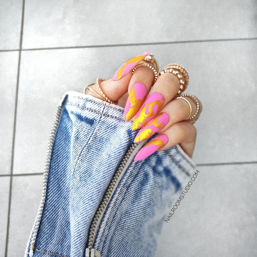 Elegant matte pink nails adorned with gold chrome for a striking and stylish finish by Nail Room Studio