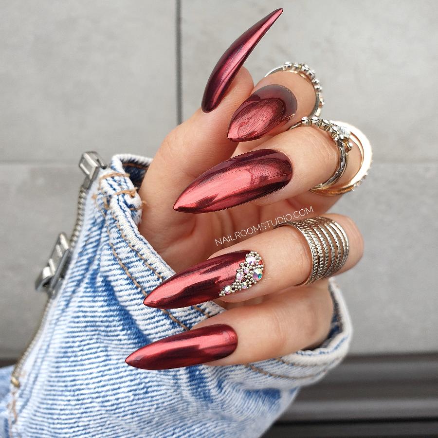 Bridal red chrome nails from Nail Room Studio with pearl and crystal accents, in a bold long chrome steel rose shape, perfect for red dresses