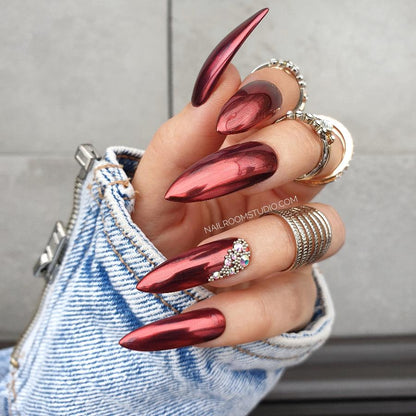 Bridal red chrome nails from Nail Room Studio with pearl and crystal accents, in a bold long chrome steel rose shape, perfect for red dresses