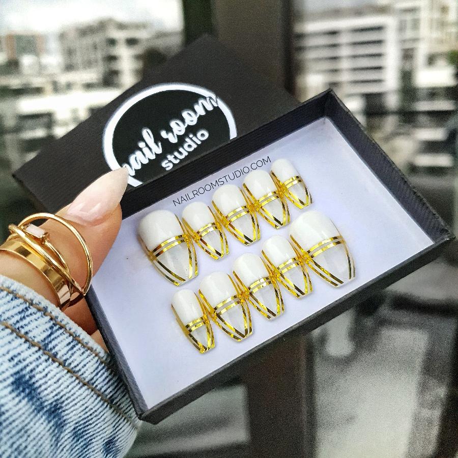 Gorgeous clear coffin nails showcasing a classic gold French design, suitable for both casual and formal occasions by Nail Room Studio