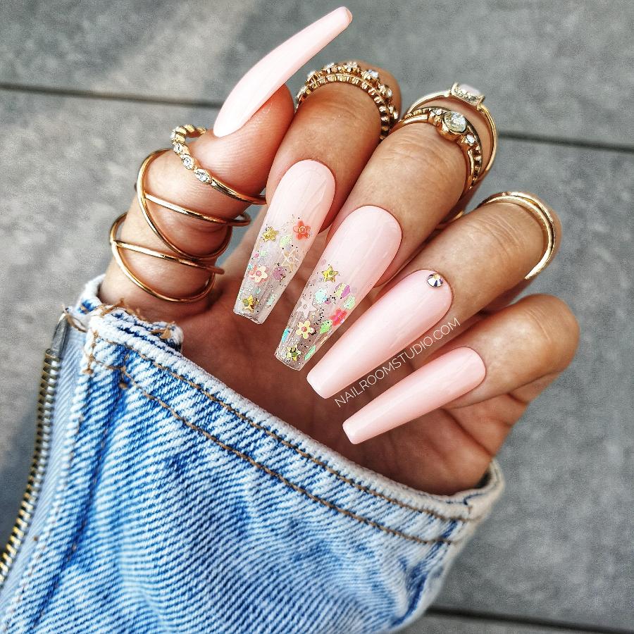 Bright pastel pink ombre nails with glittery accents, partially transparent, perfect for a light, spring vibe in long coffin shape, by Nail Room Studio