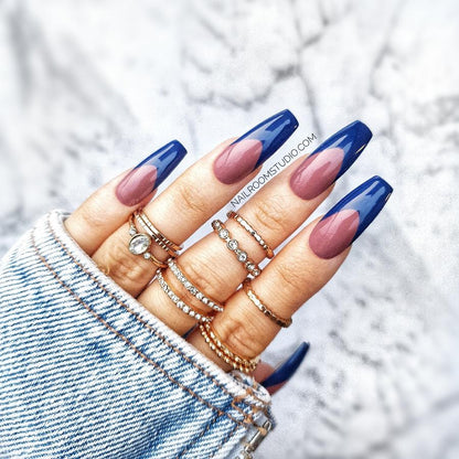 Natural French tips on navy blue nails, an elegant contrast that enhances everyday style by Nail Room Studio