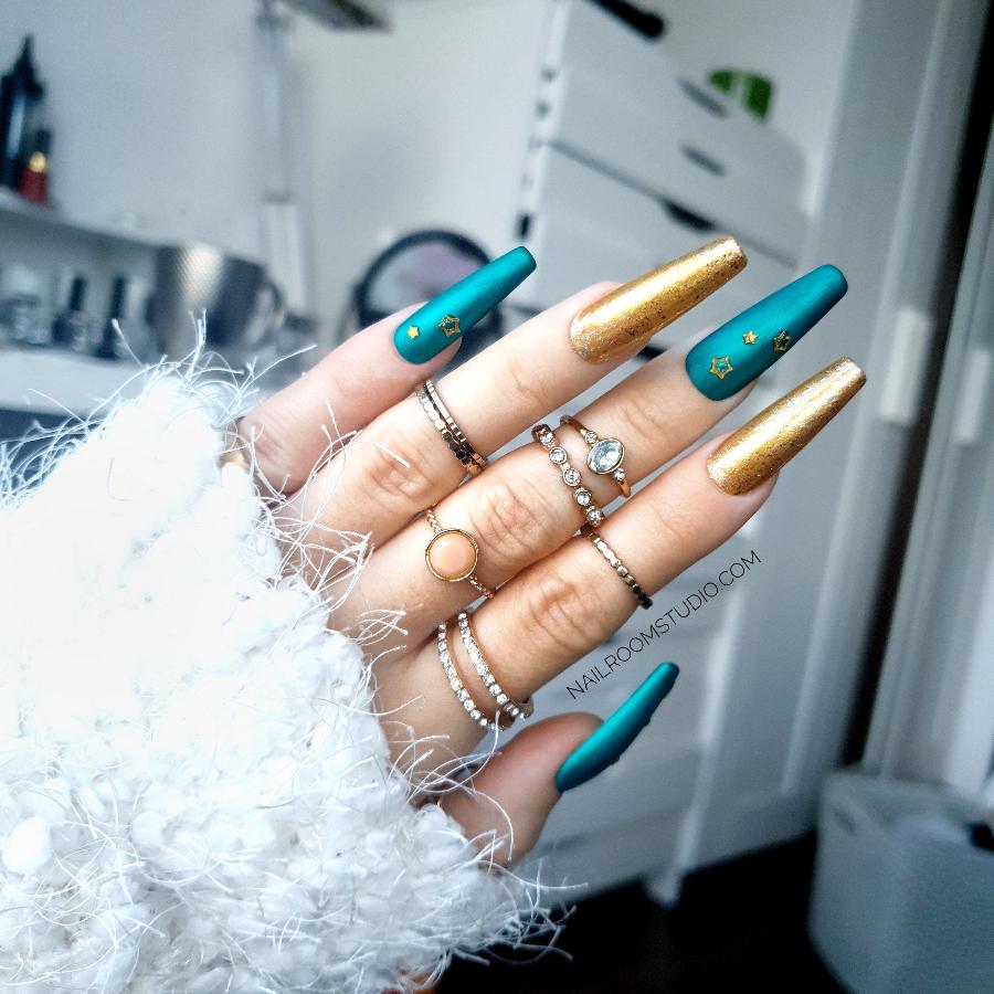 Matte green nails accented with gold chrome and star details, bringing a festive Christmas vibe for hands and toes from Nail Room Studio